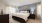 a bedroom with a bed and lamps