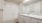 a bathroom with white cabinets