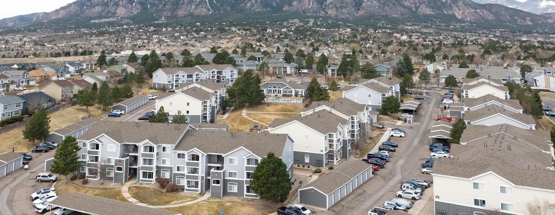 a large group of buildings with cars parked in front of them