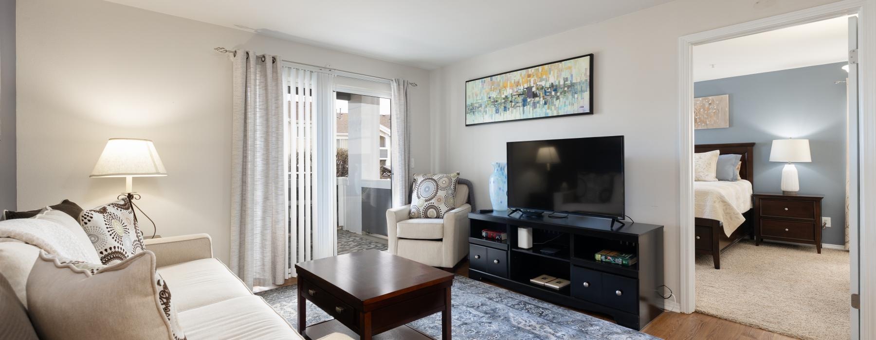 a living room with a tv and couches
